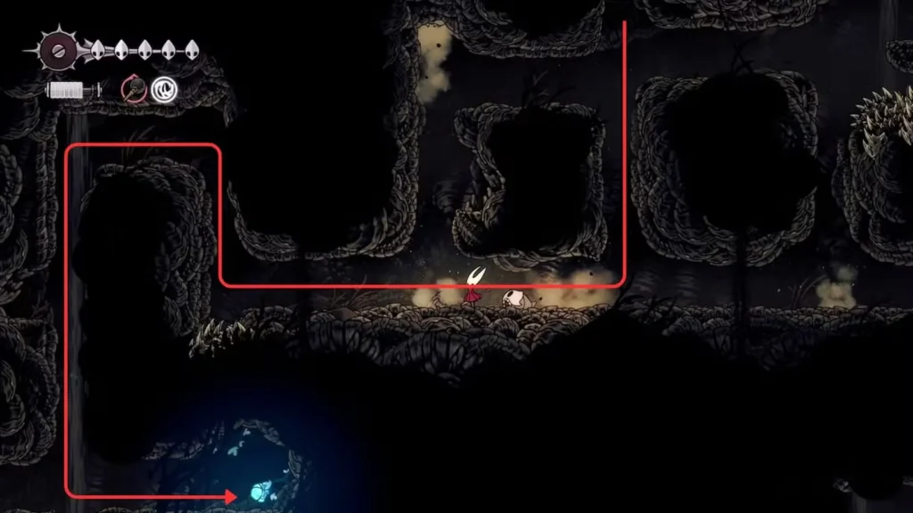 Hornet moves through Wormways' distinctive bone tunnel architecture with red arrows showing navigation route